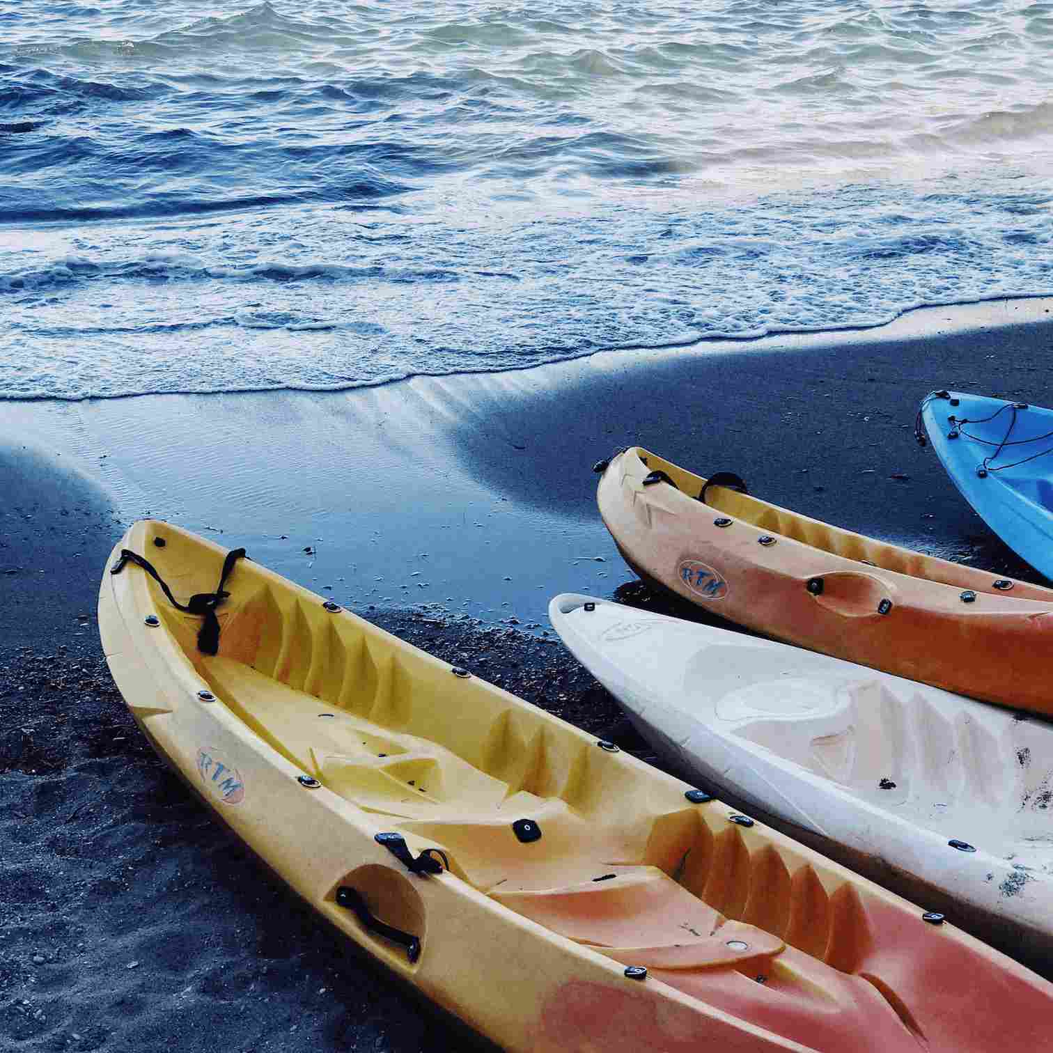 kayaks sitting on beach